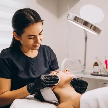 cosmetologist-cleaning-face-woman-beauty-salon